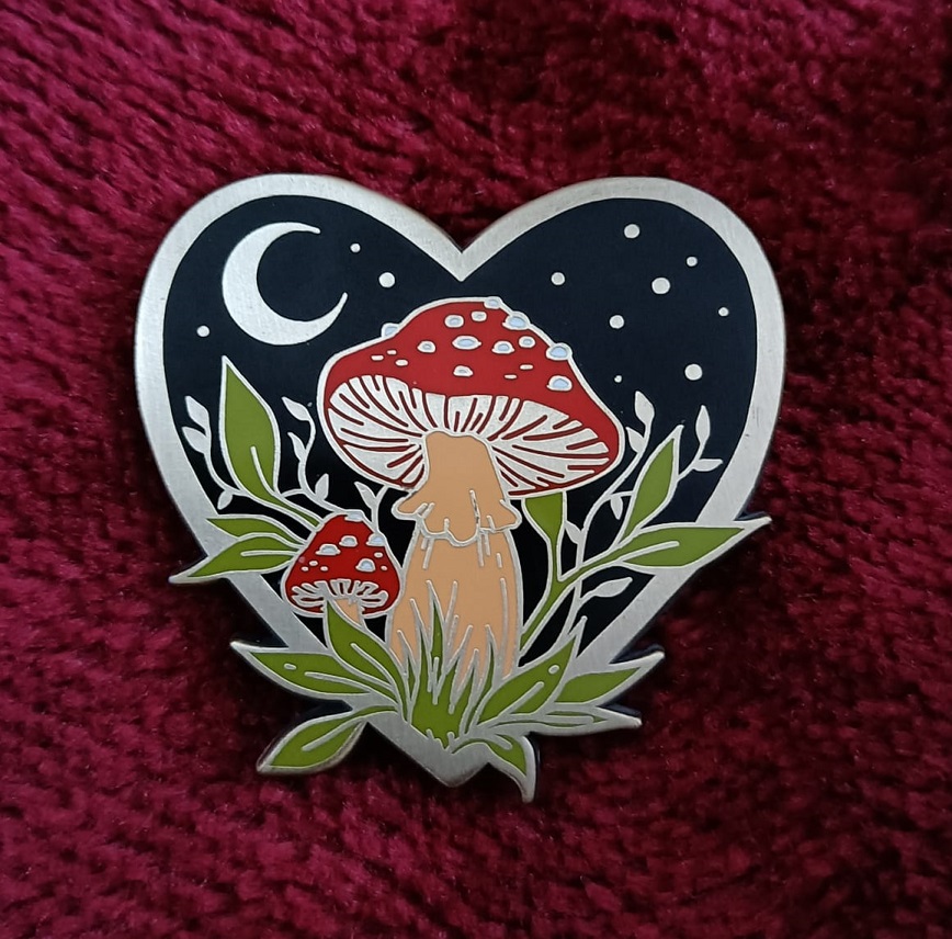 Heart shaped enamil mushroom pin, with stars, moon, large and small mushroom, by artist pepper raccoon